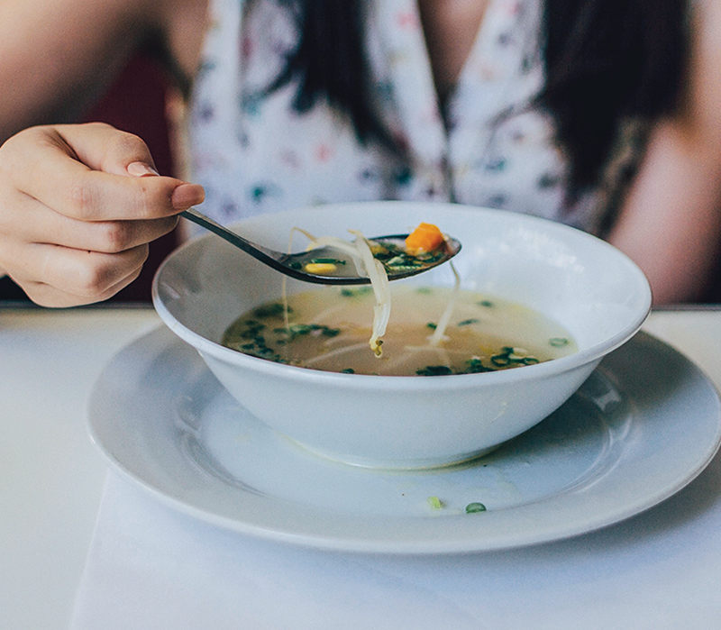 Woman eating soup